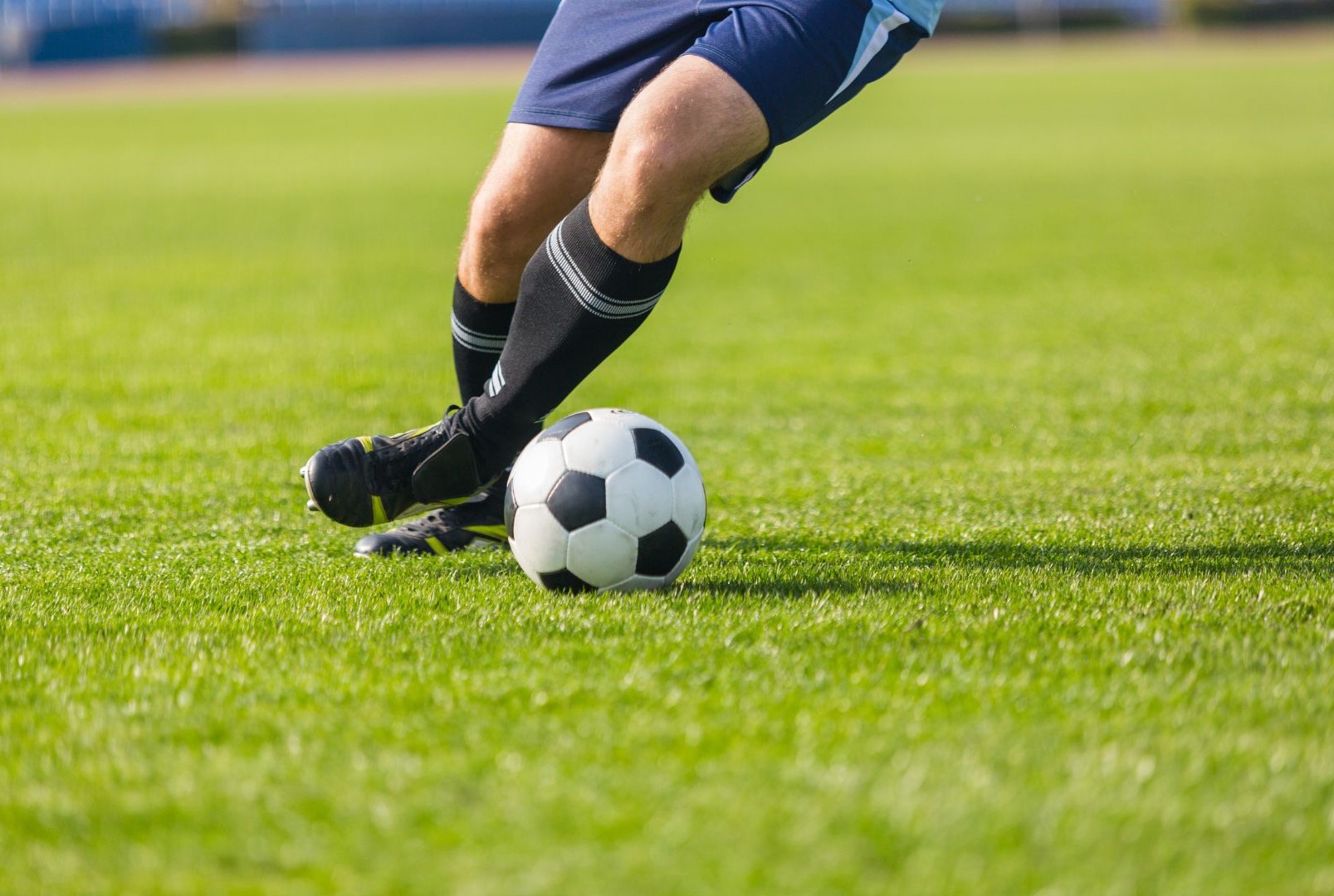 a healthy soccer player dribbling the ball